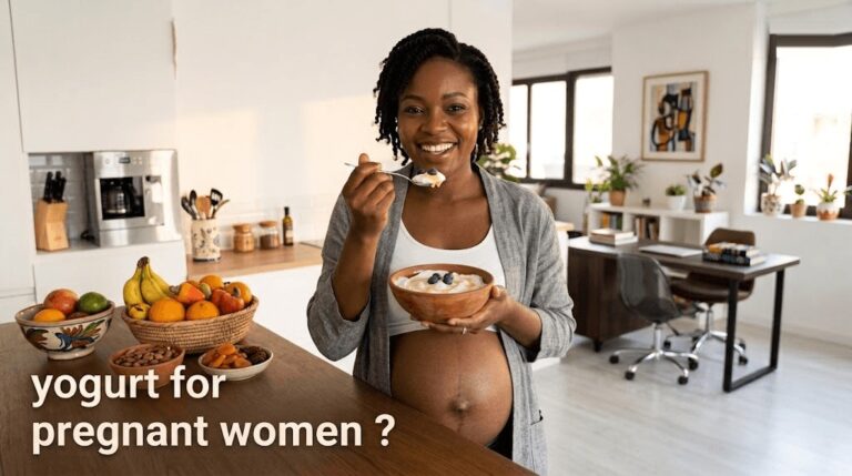 Pregnant woman eating a bowl of yogurt in her kitchen